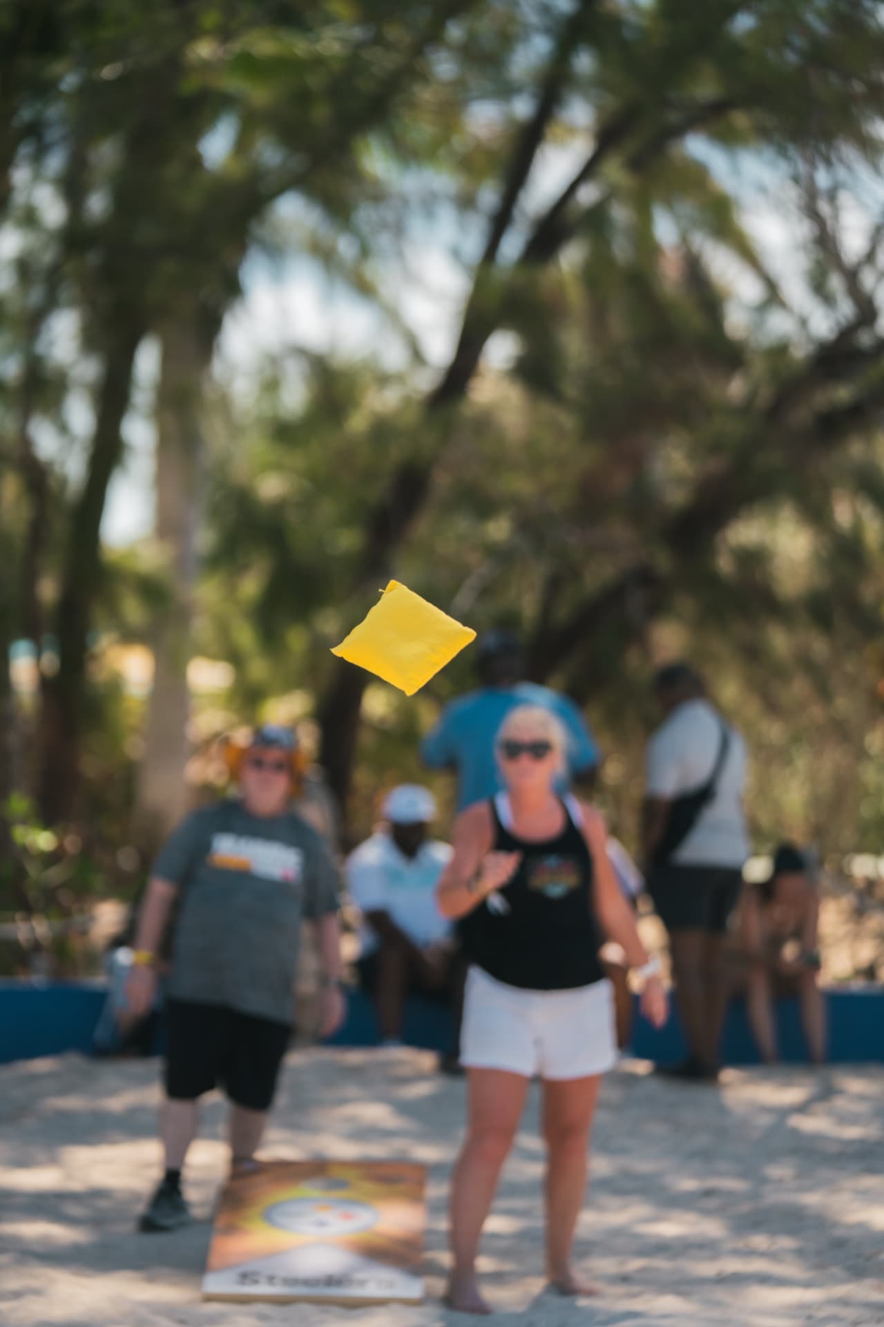Guests playing cornhole and lawn games at the resort